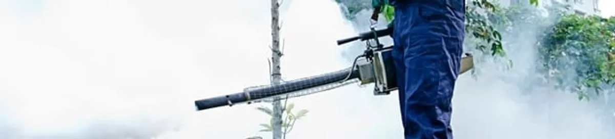 Pest control technician fogging an outdoor area for insect control in Nashua, NH